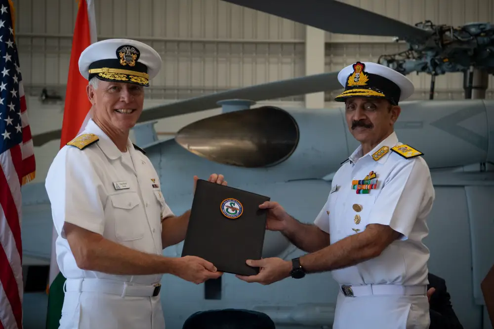 Vice Adm. Kenneth Whitesell, Commander, U.S. Naval Air Forces, left, presents the Material Inspection and Receiving Report for first aircraft to Vice Adm. Ravneet Singh, Indian Navy Deputy Chief of Naval Staff, during an acceptance ceremony at Naval Air Station North Island on Friday, July 16. 