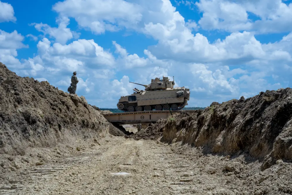 GREYWOLF Troopers with 3rd Brigade Engineer Battalion, 3rd Armored Brigade Combat Team, 1st Cavalry Division, dash across a Joint Assault Bridge (JAB) in a Bradley Fighting Vehicle during a combined arms breach exercise, Fort Hood, Texas, June 6, 2021. 