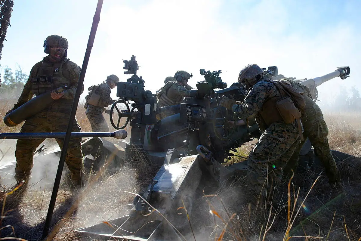 Gunners of the 4th Regiment, Royal Australian Artillery and the United States Marine Corps' Golf Battery, 2nd Battalion, 11th Marines, fire an Australian M777 Howitzer as part of a mixed crew, at Shoalwater Bay Training Area in Queensland during Exercise Talisman Sabre 2021.