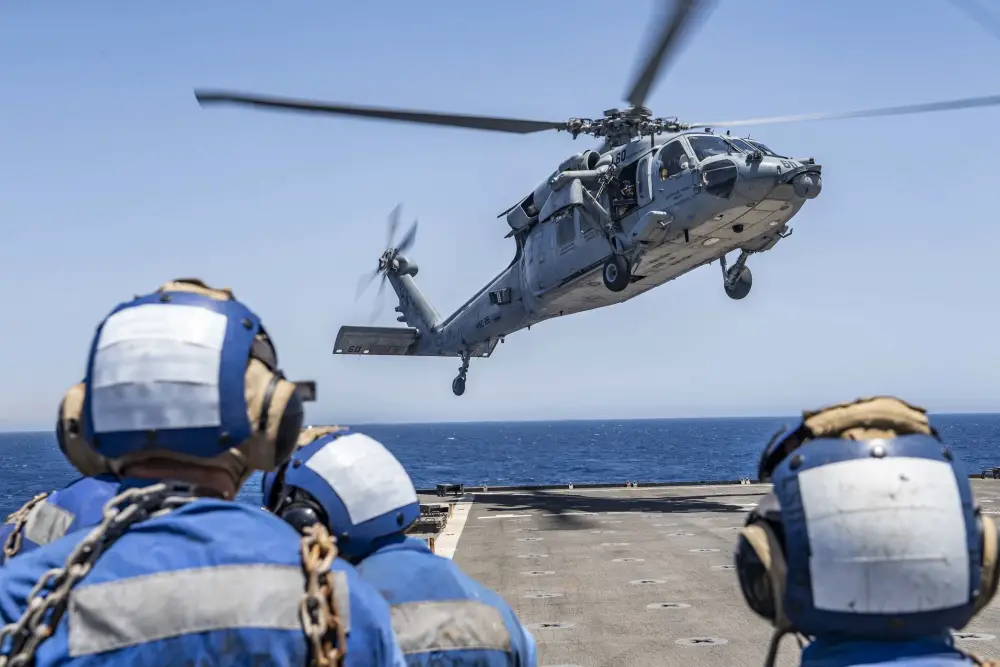  An MH-60S Sea Hawk helicopter attached to the "Chargers" of Helicopter Sea Combat Squadron (HSC) 26 approaches the flight deck of the Harpers Ferry-class dock landing ship USS Carter Hall (LSD 50), June 19.