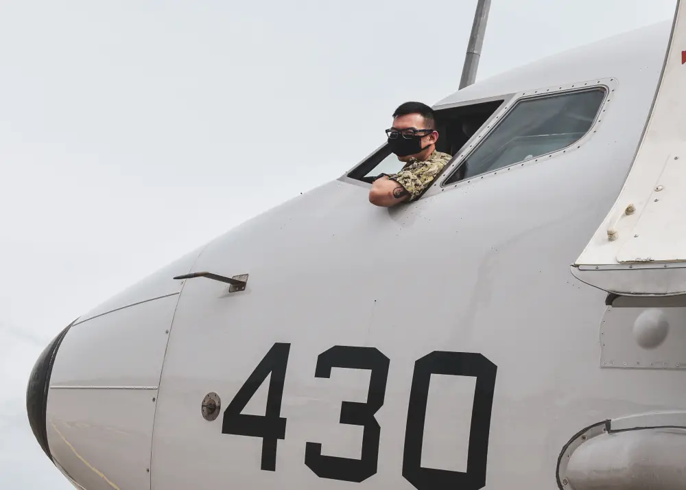 Aviation Electronics Technician 2nd Class Jacky Xu, attached to the "Red Lancers" of Patrol Squadron 10, conducts preflight checks on a P-8A Poseidon aircraft in support of a Cooperation Afloat Readiness and Training (CARAT) maritime exercise hosted by Sri Lanka. 