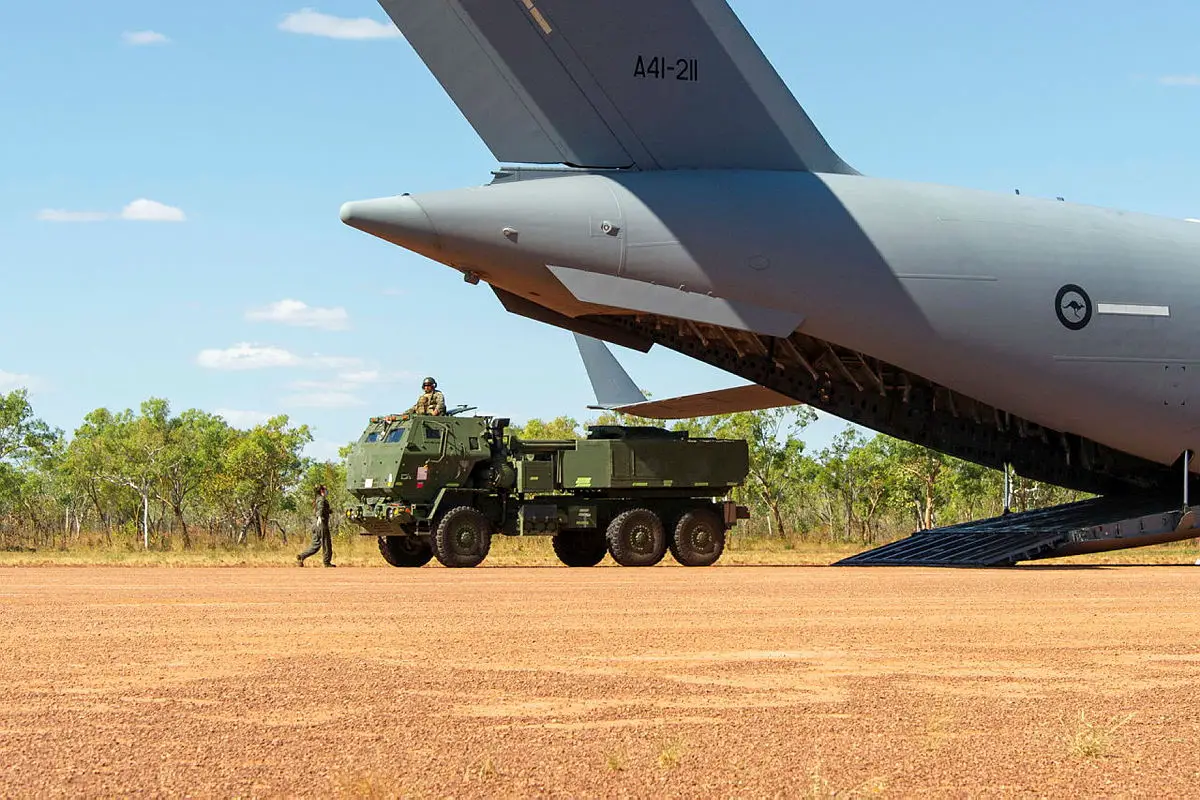 Two High Mobility Artillery Rocket Systems offload from a Royal Australian Air Force Boeing C-17 Globemaster III as part of Exercise Loobye, between the Australian Defence Force and the Marine Rotational Force – Darwin 2021 at Bradshaw Field Training Area.