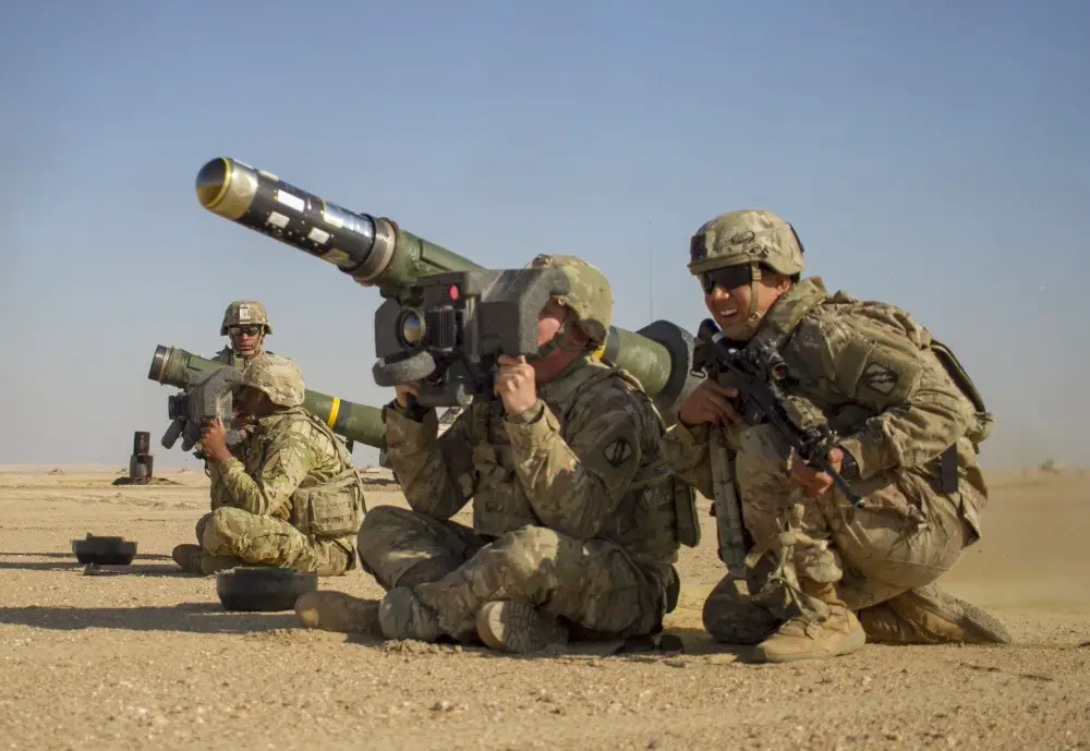 U.S. Army Pvt. Hayden Johnson, center, a cavalry scout assigned to Mississippi Army National Guard fires a Javelin shoulder-fired anti-tank missile during a combined arms live fire exercise as part of Desert Observer II the Udairi Range Complex near Camp Buehring, Kuwait.