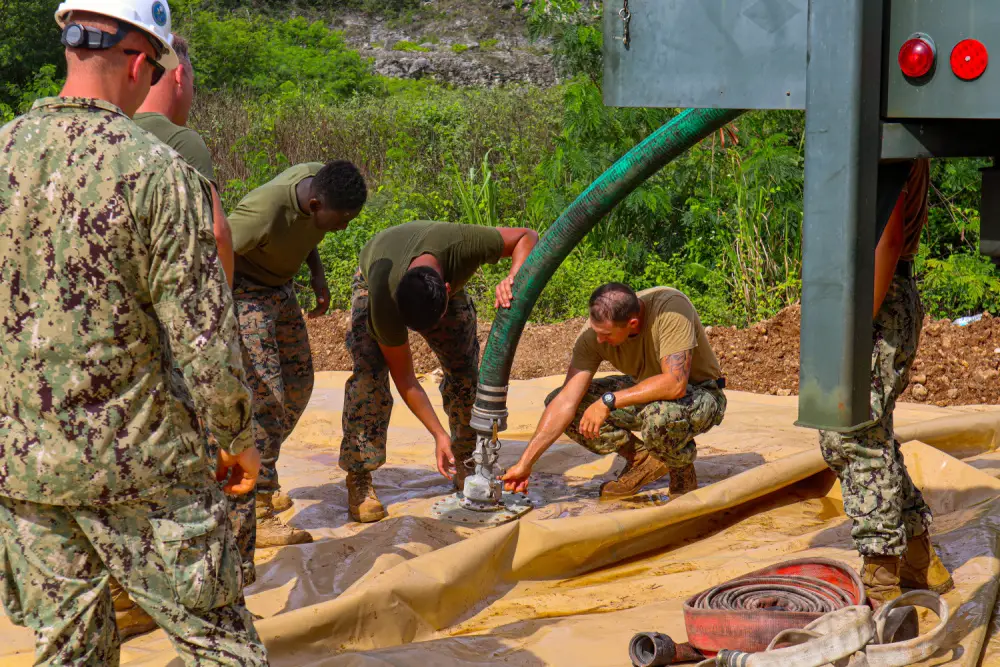 Seabees assigned to Naval Mobile Construction Battalion (NMCB) 11 Det. Guam operate a Medium Tactical Vehicle Replacement MK28C to fill a bladder for a chemical treatment mixture while supporting III MEF to establish a prototype Landing Zone using a biocement application system developed by bioMASON with support from Defense Advanced Research Projects Agency. 