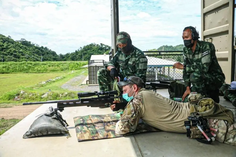  A Green Beret with 3rd Battalion, 1st Special Forces Group (Airborne), demonstrates long-range marksmanship techniques to soldiers with the Royal Thai Army as part of Cobra Gold 21 at Camp Erawan, Lopburi, Kingdom of Thailand, Aug. 5, 2021.