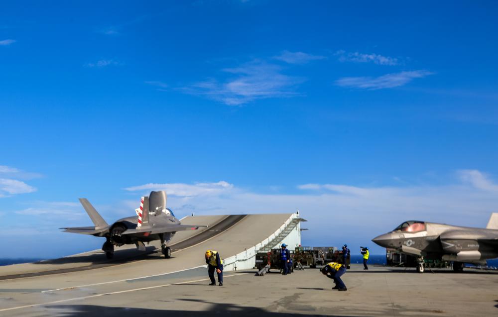 U.S. Marine Corps Maj Brian Kimmins prepares to launch an F-35B from HMS Queen Elizabeth for a historic cross-deck operation with USS America in the Pacific Ocean on August 20, 2021.