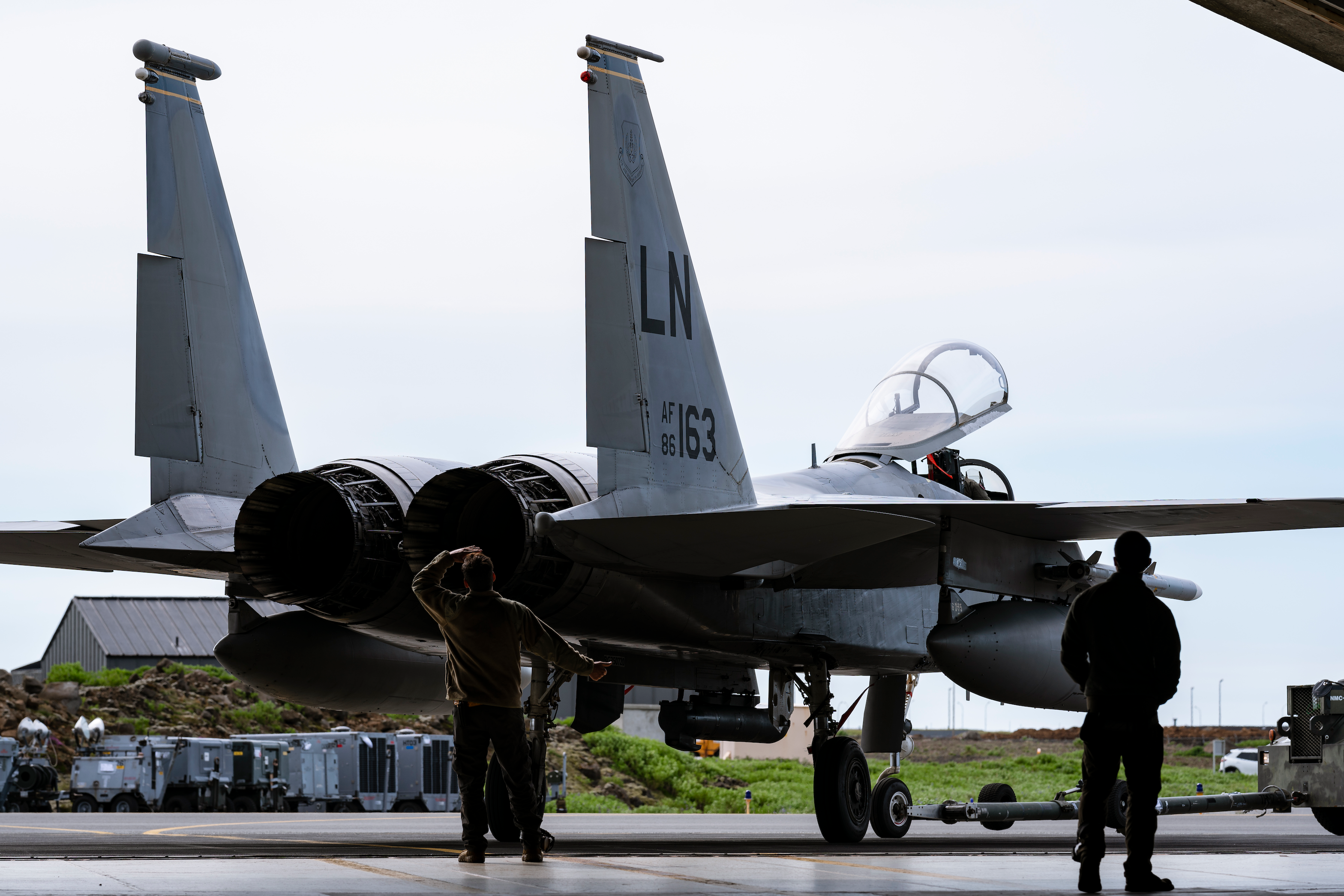 U.S. Air Force Airmen assigned to the 748th Aircraft Maintenance Squadron help guide an F-15C Eagle into a hardened aircraft shelter during NATO Air Policing operations at Keflavik Air Base, Iceland, July 27, 2021. NATO Air Policing is a peacetime collective defense mission that safeguards the integrity of NATO alliance members' airspace. (U.S. Air Force photo by Staff Sgt. Rachel Maxwell)