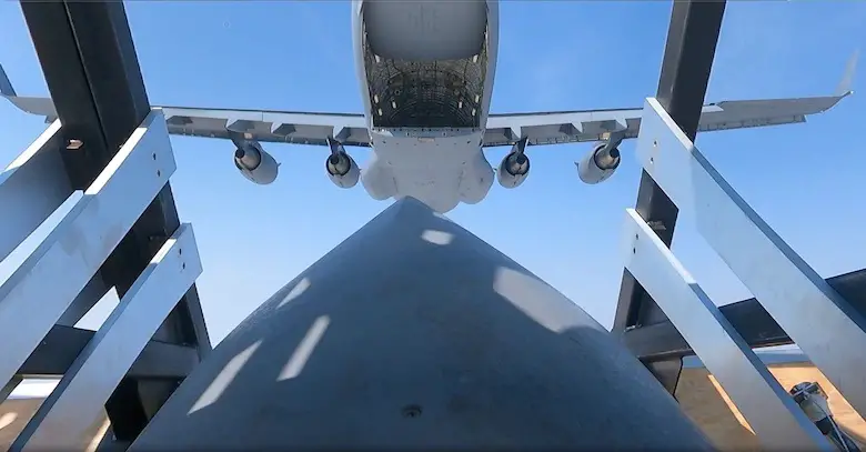 A standard cargo airdrop of the Palletized Munition Deployment System from a C-17A. A 4-pack configuration is used for demonstration purposes. 