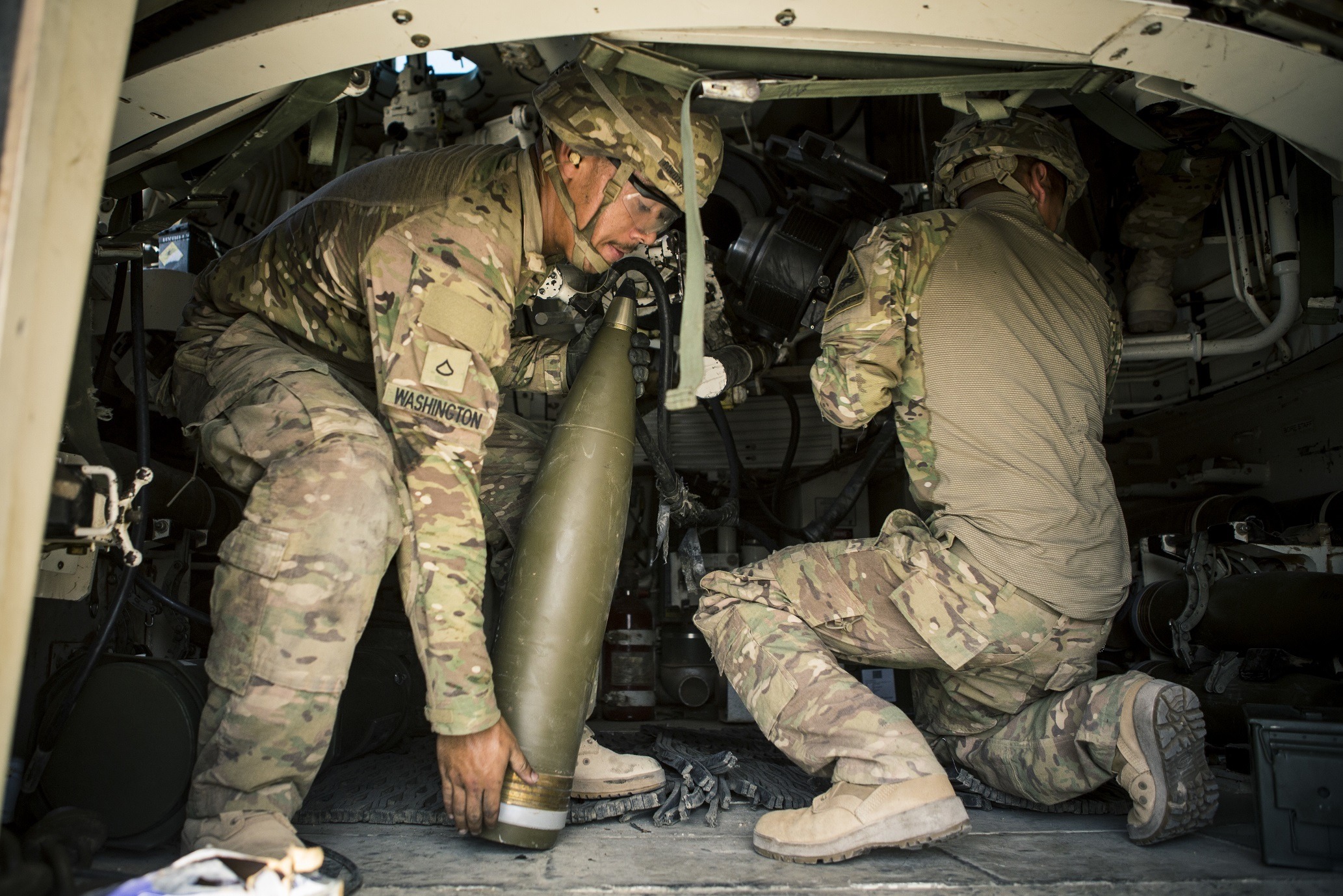 U.S. Army Soldiers with Battery C, 4th Battalion, 1st Field Artillery Regiment, 1st Armored Division, Task Force Al Taqaddum, reload an M109A6 Paladin howitzer during a fire mission at Al Taqaddum Air Base, Iraq, June 27, 2016.