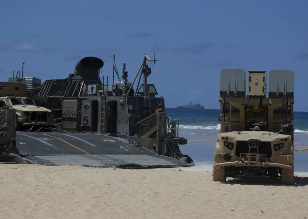 A Navy Marine Expeditionary Ship Interdiction System launcher, a command and control vehicle and a Joint Light Tactical Vehicle are transported by a U.S. Navy Landing Craft Air Cushion from Pacific Missile Range Facility Barking Sands, Hawaii, out to U.S.S. San Diego, Aug. 16, 2021.