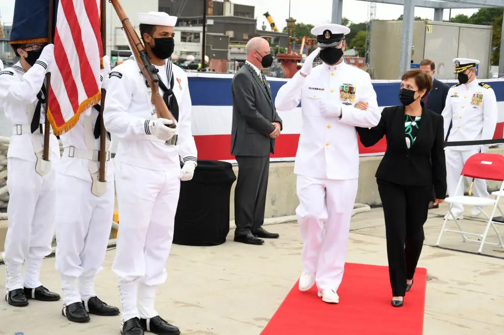 Gloria Valdez, ship’s sponsor for the USS Vermont (SSN 792), is escorted by chief of the boat Senior Chief Petty Officer Robert Antrim as part of the official party for a commissioning commemoration onboard Naval Submarine Base New London in Groton, Conn., Aug. 28.