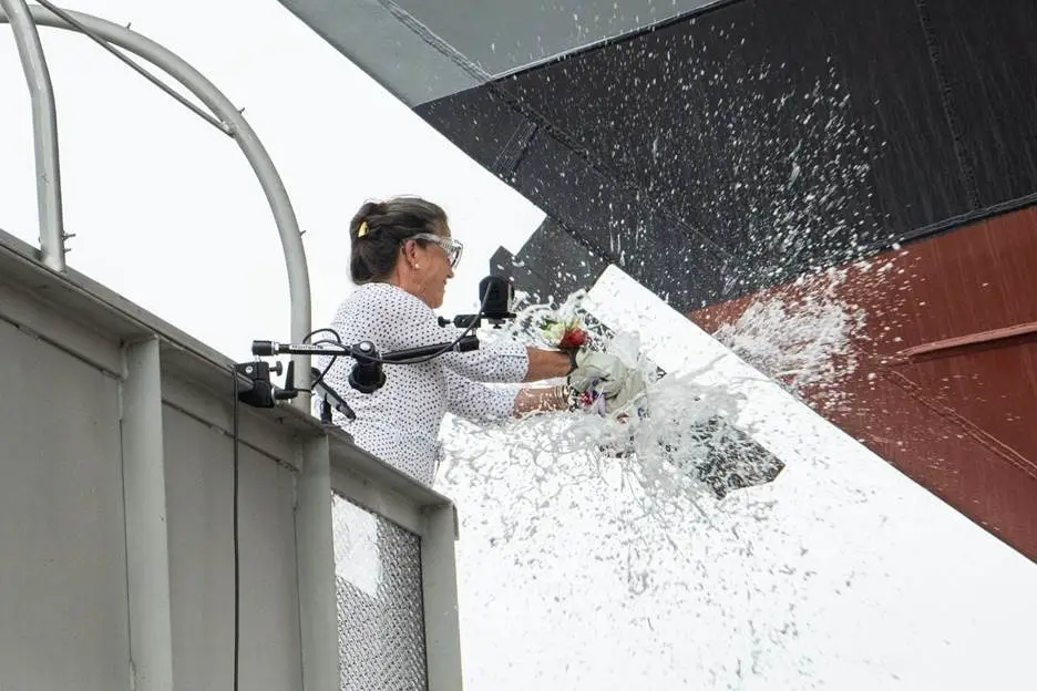Ship Sponsor Polly Spencer Breaks A Bottle Of Sparkling Wine Across The Bow During The Christening Ceremony For The Nation’s 27th Littoral Combat Ship, The Future USS Nantucket.