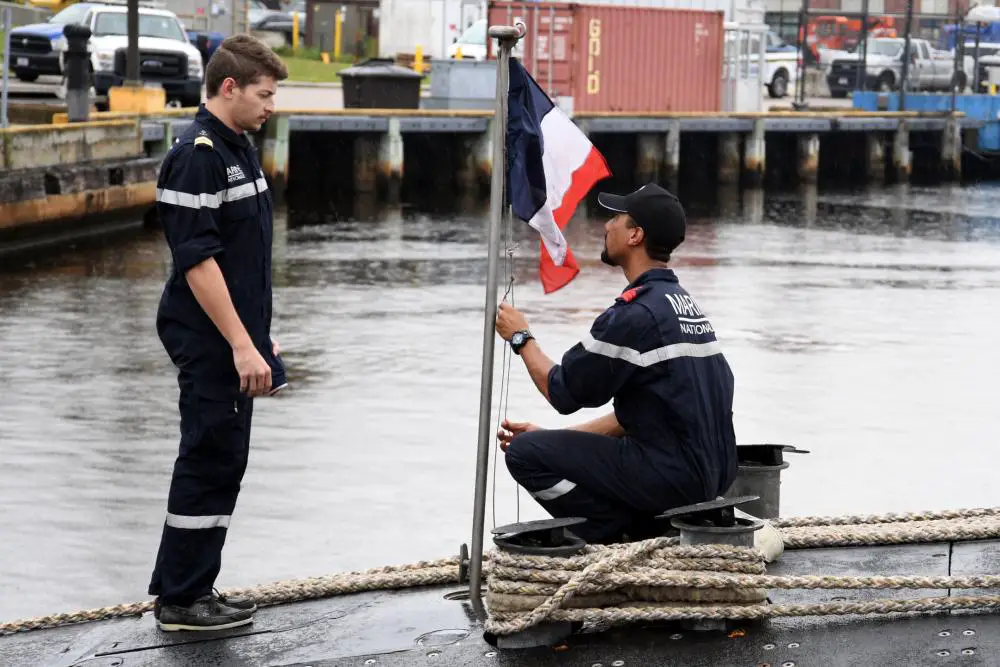 Crewmembers assigned to the French submarine FNS Amethyste (S605) raise their flag after arriving at Naval Submarine Base New London in Groton, Connecticut.