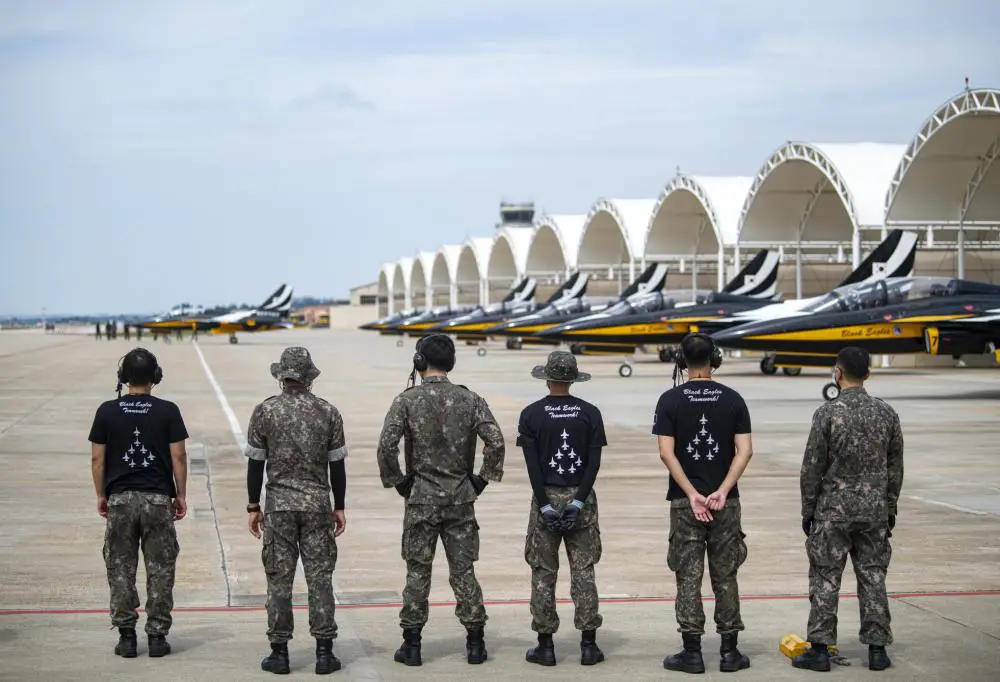 Republic of Korea Air Force Black Eagle maintainers watch as eight Black Eagle T-50 aircraft prepare to take-off for an aerial demonstration at Kunsan Air Base, ROK, Sept. 9, 2021. 