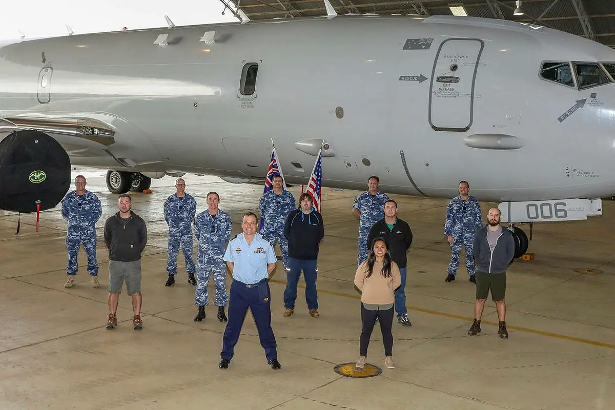 Officer Commanding No. 92 Wing, Group Captain John Grime, front centre, stands with staff and personnel from Surveillance and Response Systems Program Office, No. 92 Wing and Boeing in front of P-8A Poseidon A47-006. Photo: Corporal Brenton Kwaterski 