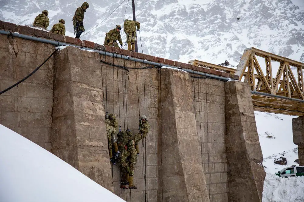 U.S. Army soldiers assigned to Bravo Company, 2nd Battalion, 87th Infantry Regiment, 2nd Brigade Combat Team, 10th Mountain Division, rappel off a bridge at the Chilean Army Mountain School in Portillo, Chile, Aug. 20, 2021.