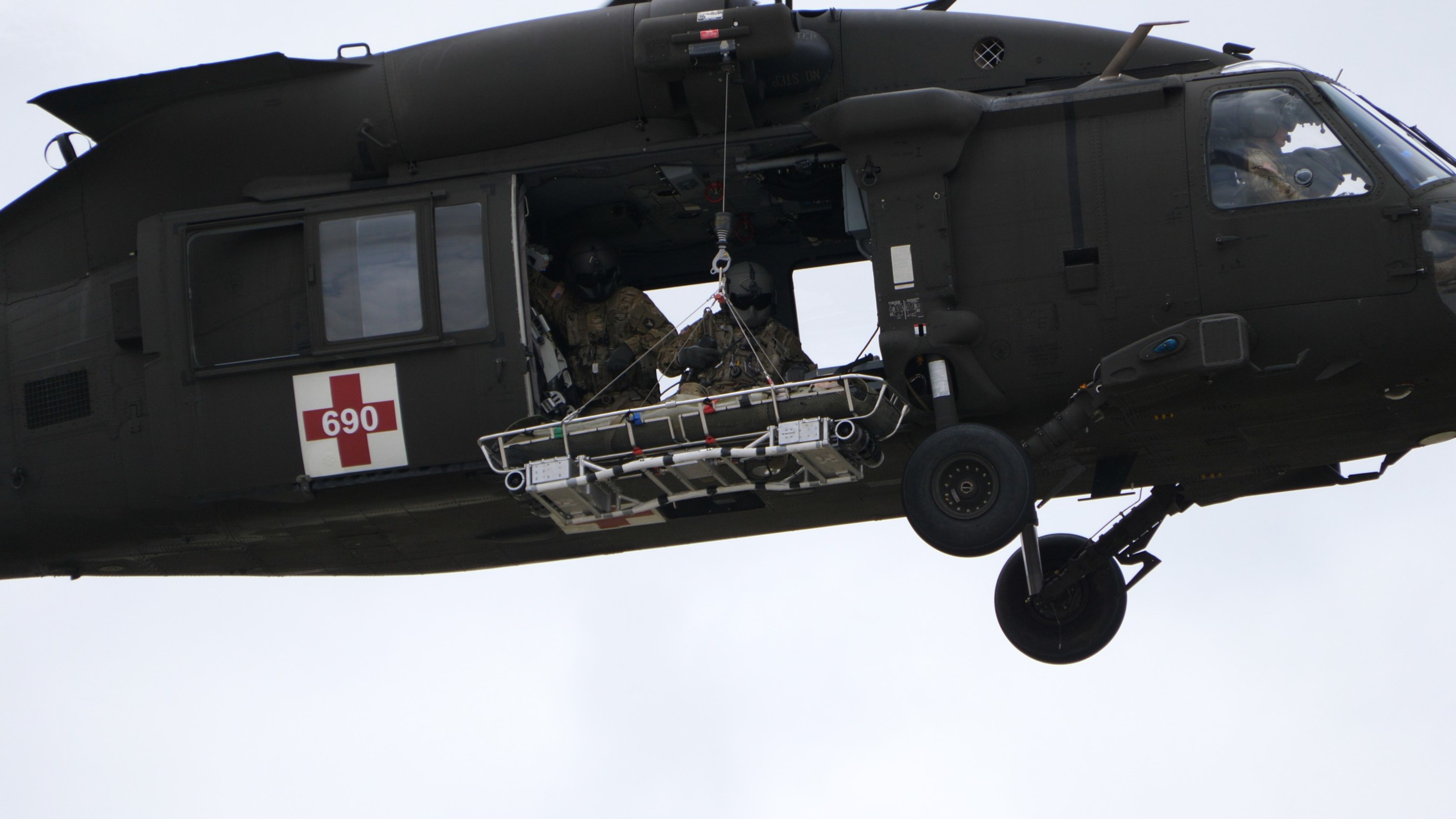 The Vita Rescue System Litter Attachment Under a Black Hawk Helicopter