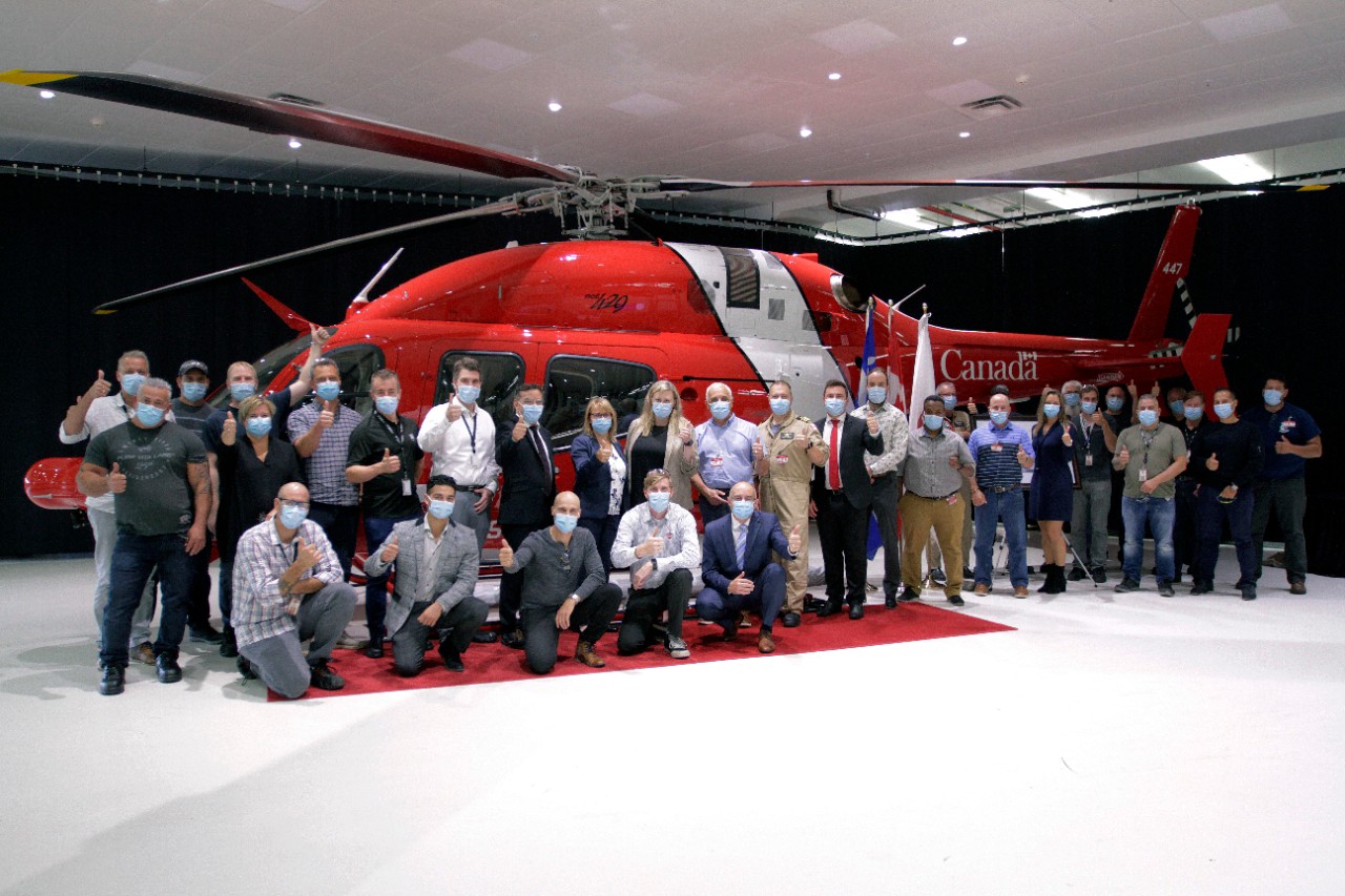 Canadian Coast Guard and Bell Textron Canada staff pose in front of the 16th Bell 429 helicopter delivered to the Coast Guard