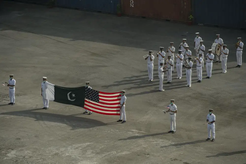 ) Pakistani Sailors form a welcome party for amphibious dock landing ship USS Pearl Harbor (LSD 52), during a port visit to Karachi, Pakistan, Nov. 9. 