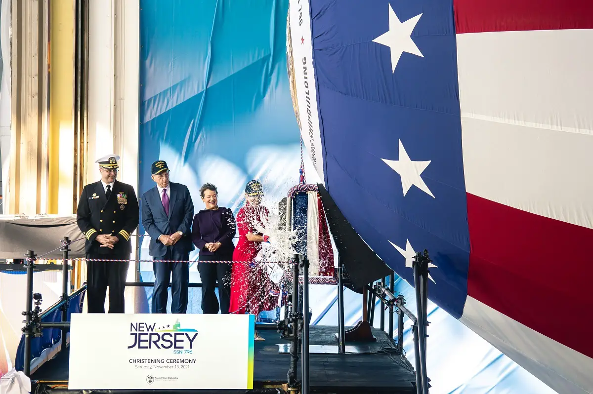 Ship's sponsor Susan DiMarco christens pre-commissioning unit New Jersey (SSN 796) during ceremony on Saturday, Nov. 13, 2021 at Newport News Shipbuilding. 
