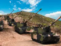 Hanwha Defense Australia AS9 Huntsman 155mm Self-Propelled Howitzers (SPHs) and A10 Armoured Ammunition Resupply Vehicles (AARV).