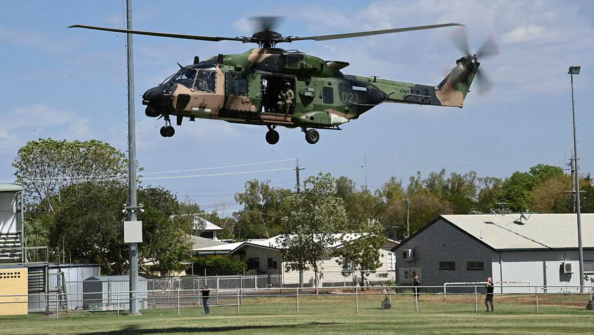 An Australian Army MRH90 Taipan helicopter from the 5th Aviation Regiment prepares to land at the Recreation grounds at Cloncurry, Queensland.