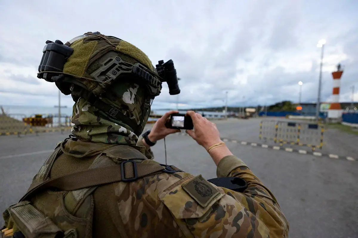 Australian Army Lance Corporal Callum Evans from Joint Task Group 637.3, photographs the rove port during a reconnaissance patrol in the Solomon Islands on 28 November 2021.