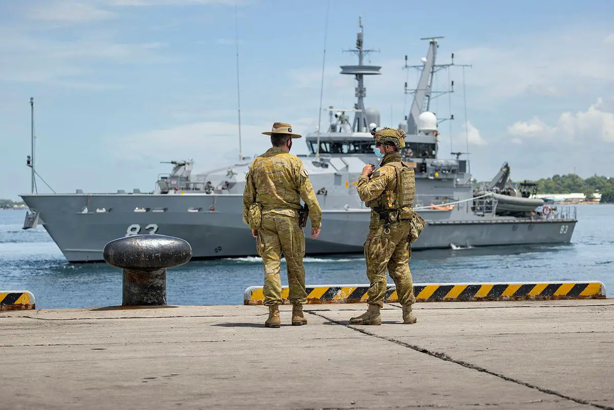 Commander of Joint Task Group 637.3, Lieutenant Colonel Steve Frankel (left), and Private Thomas Rixon, watch the Armidale Class Patrol Boat, HMAS Armidale, sail into the Port of Honiara, Solomon Island on 01 December 2021.
