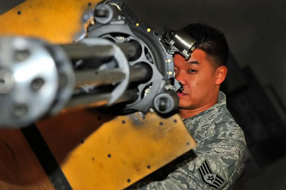 U.S. Air Force Staff Sgt. Thanh Nguyen, 372nd Training Squadron Detachment 202 F-16 armament systems instructor and scheduler, examines a M61A1 Vulcan cannon at Shaw Air Force Base, S.C.