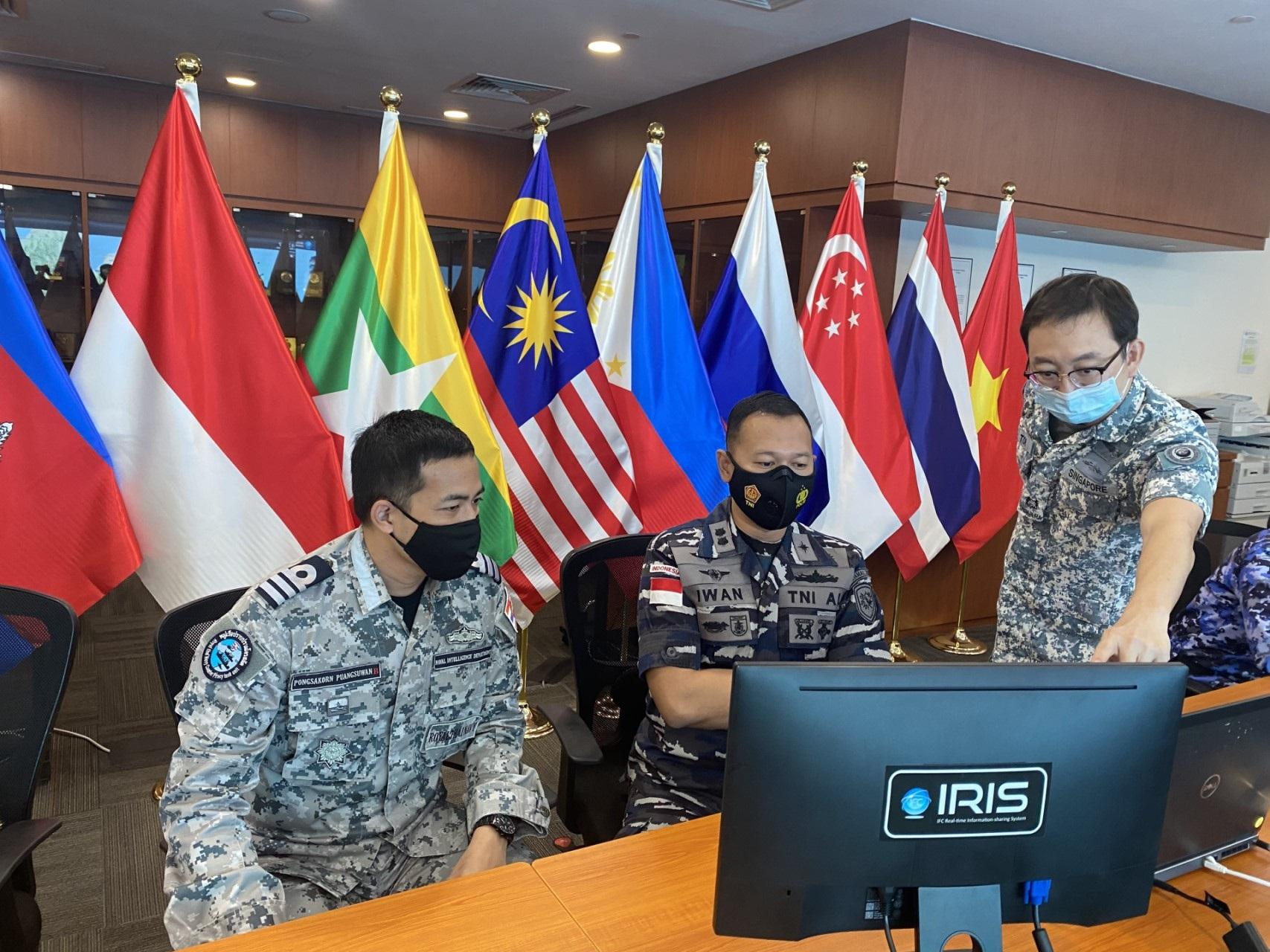 ASEAN International Liaison Officers and a Republic of Singapore Navy (RSN) personnel tracking the movement of simulated vessels of interest using the  RSN's Information Fusion Centre Real-time Information-sharing System during the exercise.