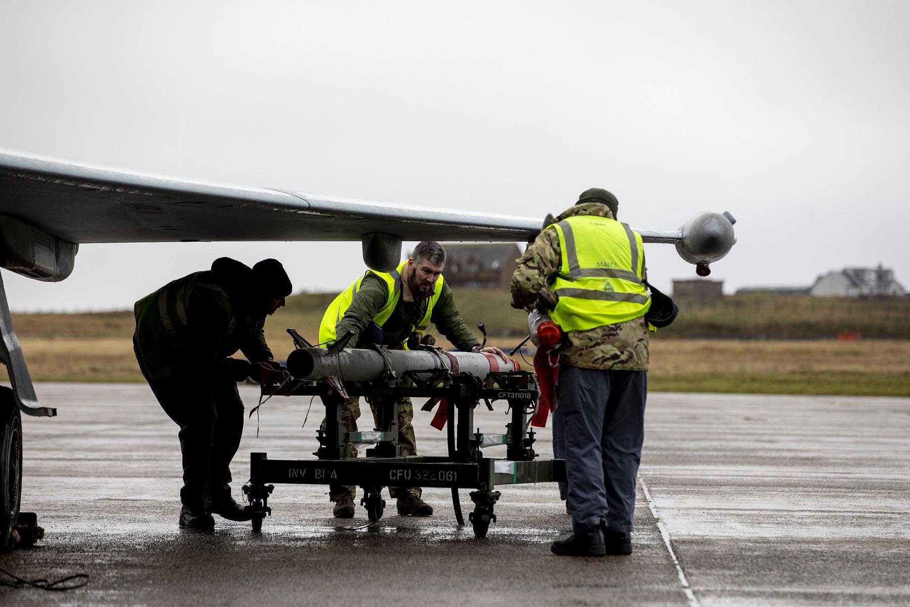 Personnel from Royal Air Force Marham carrying out work on a RAF Eurofighter Typhoon Fighters.