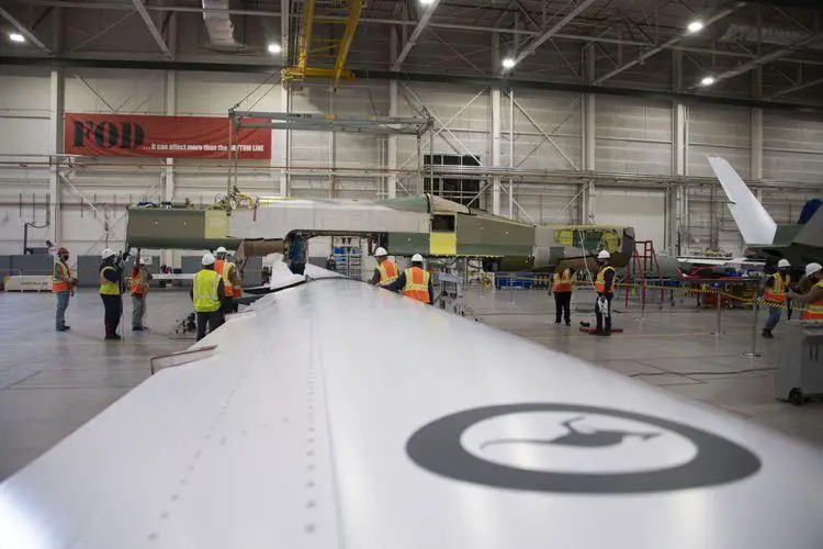 Australia’s first MQ-4C Triton fuselage is lowered onto the unique one-piece wing.