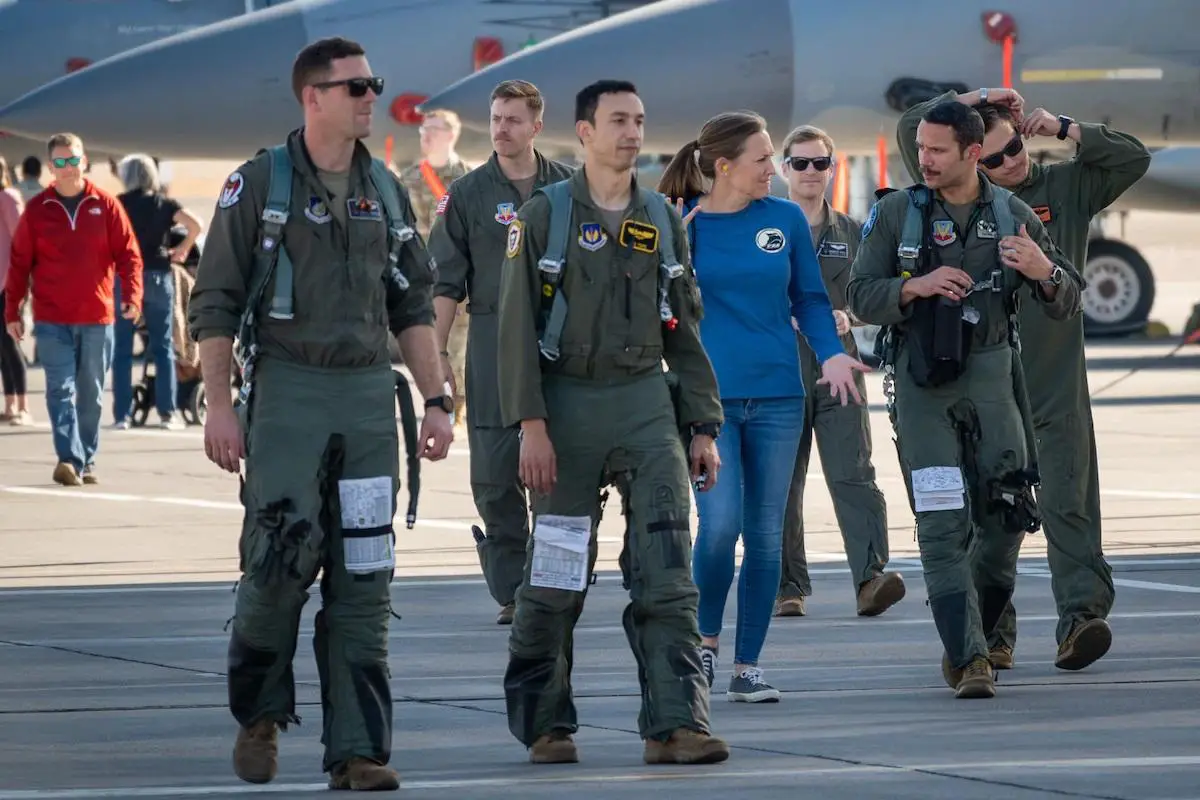 United States Air Force Weapons School instructors and students, including Maj. Michael Tope and Maj. Rodolfo Cruz (center) walks toward the hangar following a defensive combat air Vul at Nellis Air Force Base, Nevada, on Dec. 8, 2021. This flight marked the final flight for the F-15C Weapons Instructor Course.