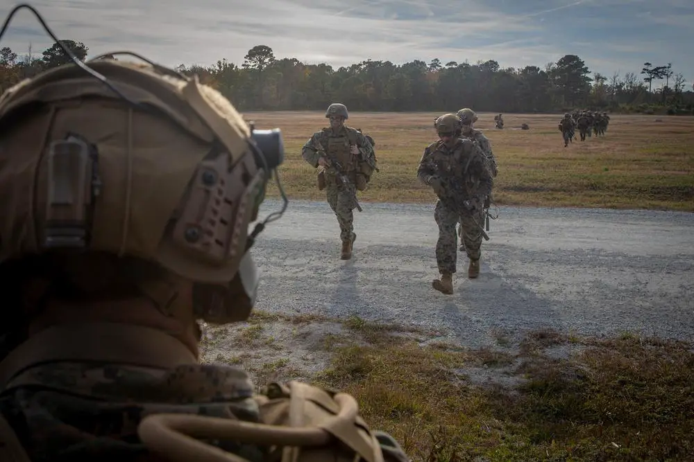 U.S. Marines with 2d Battalion, 2d Marine Regiment, 2d Marine Division, move from their security position during an operational evaluation of the CH-53K King Stallion at Camp Lejeune, N.C., Nov. 21, 2021.