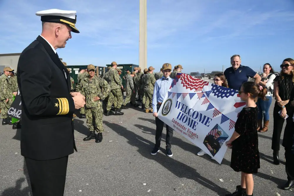 Rear Adm. Jim Aiken, Commander, U.S. Naval Forces Southern Command/U.S. 4th Fleet meets the family of Cmdr. Daniel Virgets, executive officer of the Freedom-variant littoral combat ship USS Sioux City (LCS 11) (Gold Crew), as the ship returns home from a deployment to the U.S. 4th Fleet area of responsibility, Dec. 17, 2021.