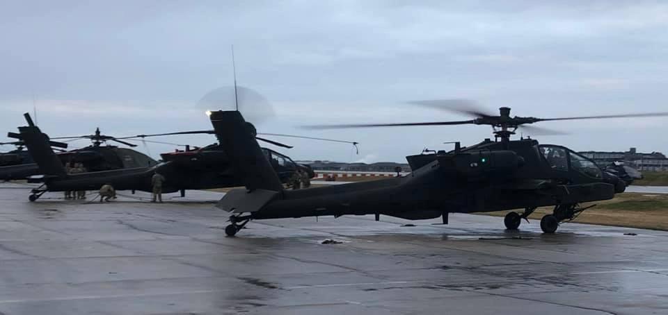 A group of Apache AH-64E Version 6 helicopters sits on the flight line of at Camp Humphreys, South Korea. 