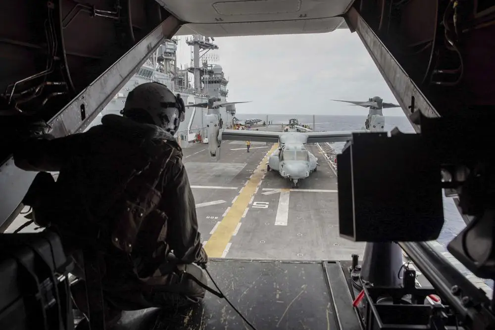 A U.S. Marine assigned to Marine Medium Tiltrotor Squadron (VMM) 165 (Reinforced), 11th Marine Expeditionary Unit (MEU), observes the landing from inside an MV-22B Osprey attached to VMM-165 (Rein.), 11th MEU, after conducting routine operations in support of Exercise Noble Fusion, Feb. 3, 2022.