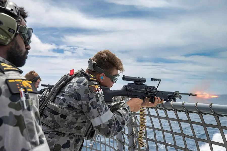 Leading Seaman Nathan Bob, left, directs Able Seaman Bradley Hocking as he fires an F89 Minimi on the flight deck of HMAS Arunta in the lead-up to the ship's regional presence deployment. 