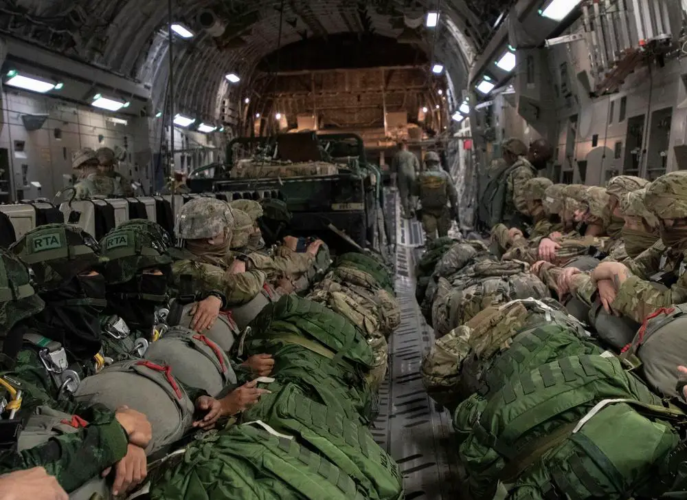 U.S. Army Paratroopers assigned to 4th Infantry Brigade Combat Team (Airborne), 25th Infantry Division and Royal Thai Army Paratroopers wait aboard a U.S. Air Force C-17 Globemaster III transport aircraft at McChord Field, Joint Base Lewis-McChord, Washington, Feb. 18, 2022. 