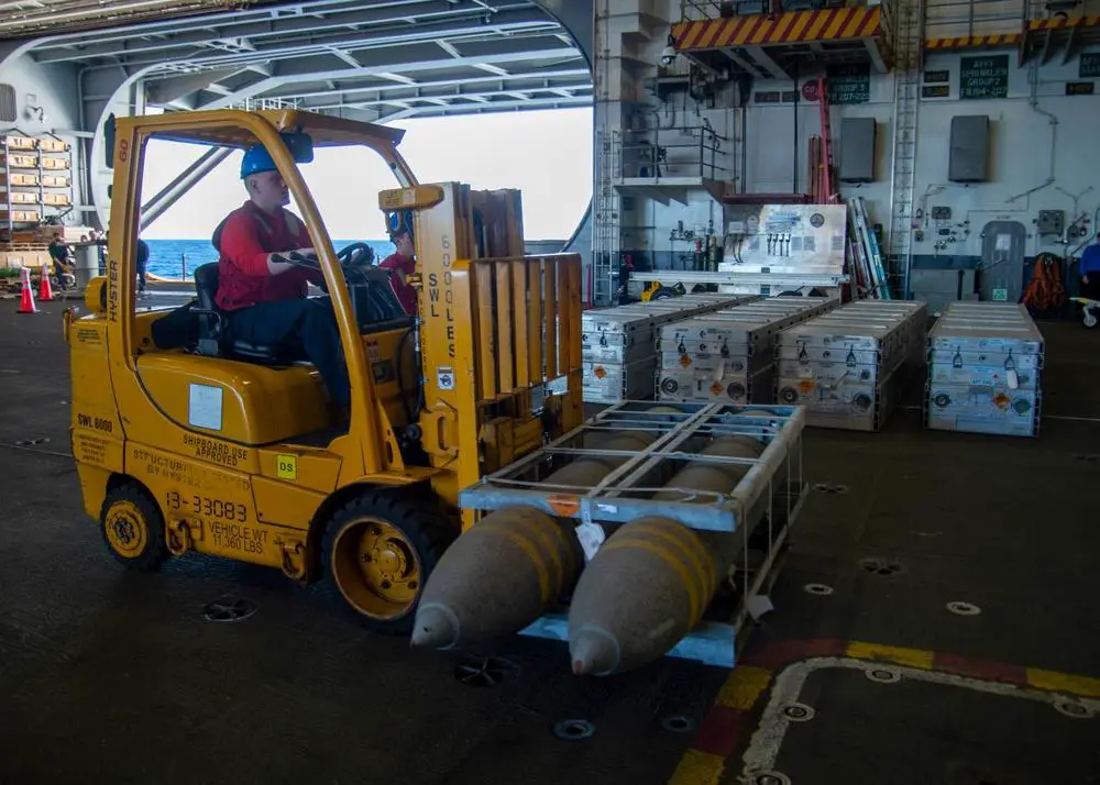 A Sailor aboard the aircraft carrier USS George H.W. Bush (CVN 77) transports ordnance during an ammunition onload with the dry cargo and ammunition ship USNS Medgar Evers (T-AKE 13), Feb. 3, 2022. 