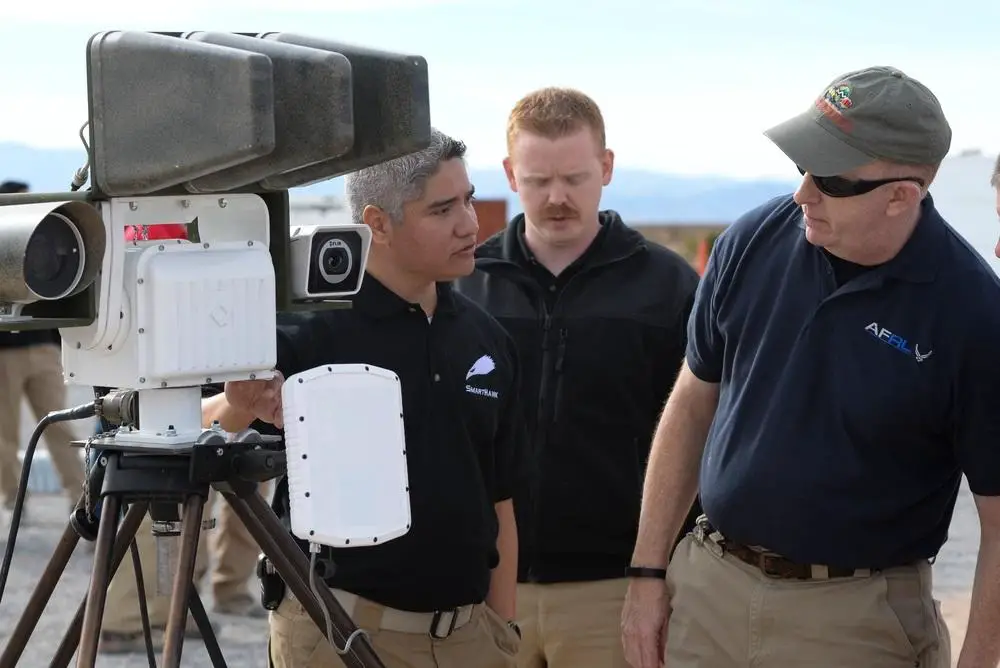 Jerome Ramirez U.S. Air Force Staff Sgt. Michael Ingold brief Maj. Gen. Robert D. McMurry, Air Force Research Laboratory commander, on his teams, counter unmanned aerial system solution, Dec. 14, 2016, during the AFRL Commanders Challenge at the Nevada National Security Site, Las Vegas, NV., Dec. 13, 2016. 
