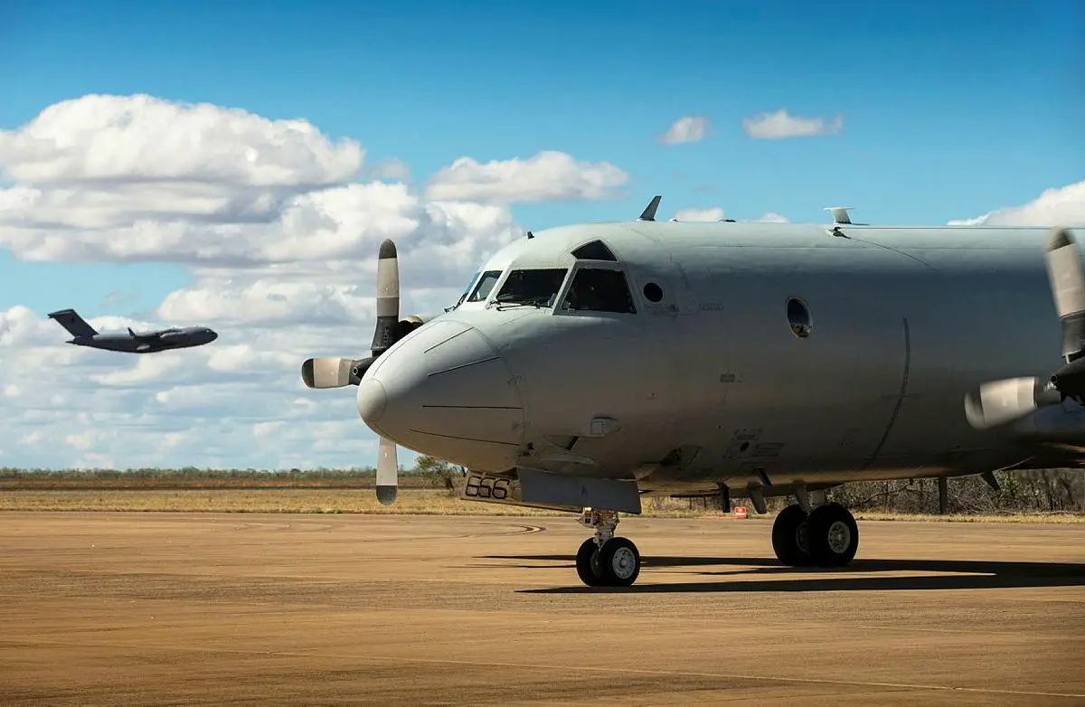 A No 36 Squadron C-17A Globemaster III takes off from RAAF Base Curtin as an AP-3C Orion starts its engines