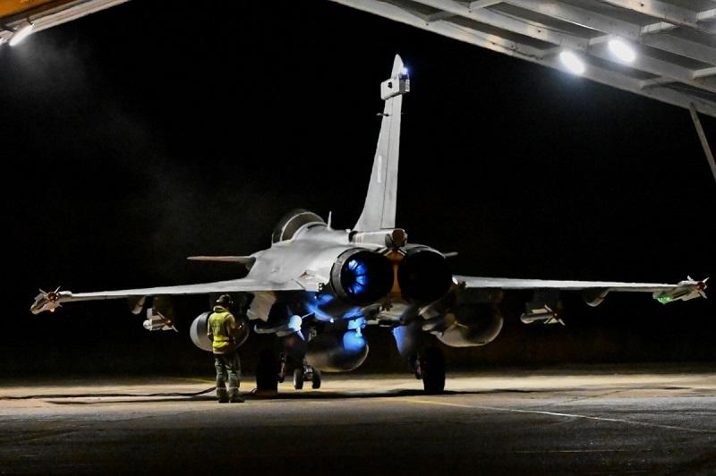 A French Air and Space Force Rafale fighter aircraft during pre-flight checks in a hangar at the home base at Mont-de-Marsan. 
