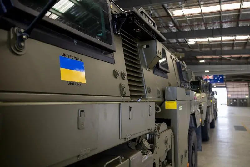 Thales Bushmaster protected mobility vehicles bound for Ukraine wait to be loaded onto a C-17A Globemaster III aircraft at RAAF Base Amberley. 