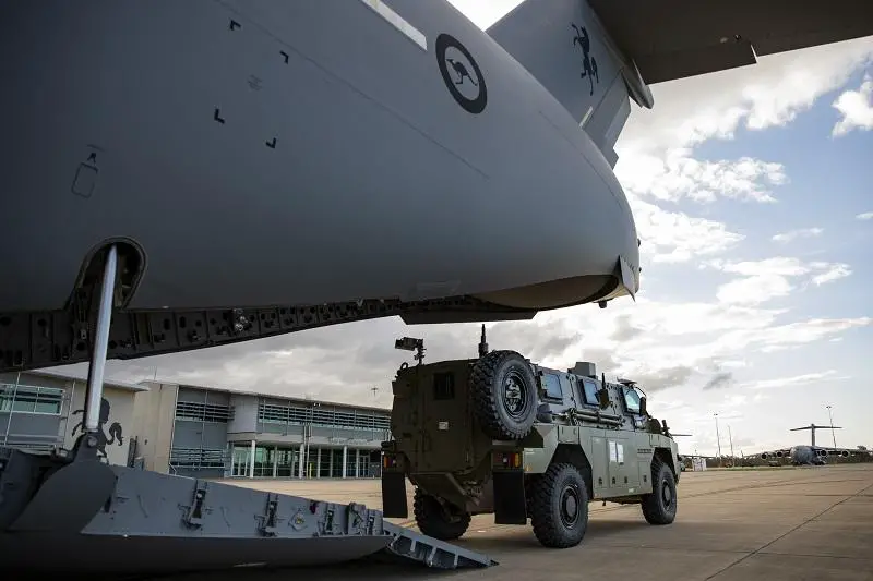 Thales Bushmaster protected mobility vehicles bound for Ukraine wait to be loaded onto a C-17A Globemaster III aircraft at RAAF Base Amberley.