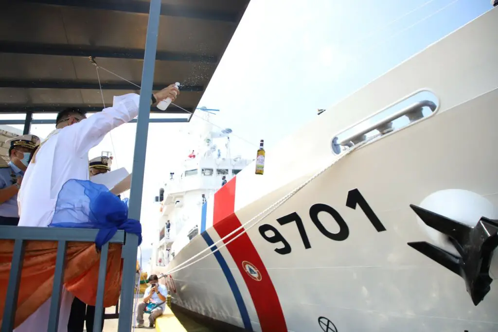 A bottle of wine is about to be broken on the hull of the MRRV-9701 as part of its commissioning as "BRP Teresa Magbanua" by the Philippine Coast Guard (PCG). 