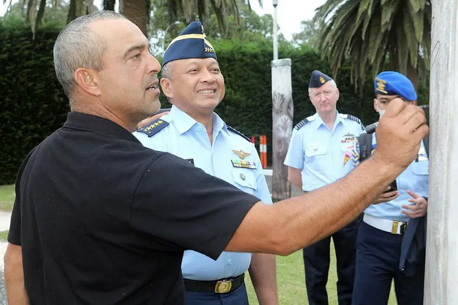Chief of Staff, Indonesian Air Force, Air Chief Marshal Fadjar Prasetyo, has his hand traced on a totem pole to symbolise his visit and journey throughout Gunaikurnai country by Gunaikurnai Lands and Waters Aboriginal Corporation representative Alfred ‘Alfie’ Hudson. 