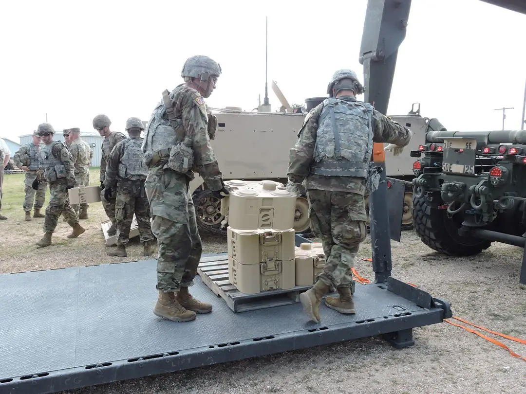 Soldiers from the 595th Sapper Company load TSO dispenser launcher modules onto a Palletized Load System truck in support of a Soldier Touch Point for PM CCS/Product Manager TSO. 
