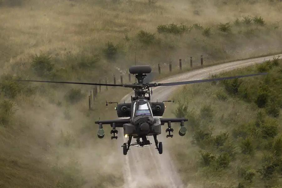 An Apache attack helicopter model 64E flying just feet from the ground along a track on Salisbury Plain Training Area.