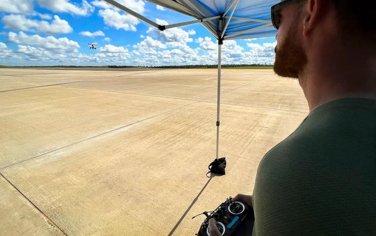 Luke Reddaway, a LIFT team member, pilots the Hexa aircraft via remote control during its first flight at Eglin Air Force Base, Fla., July 7, 2022. The aircraft, which used 18 motors and propellors, flew for approximately 10 minutes and reached a height of about 50 feet.